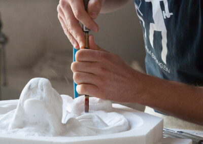 Hands carving stone