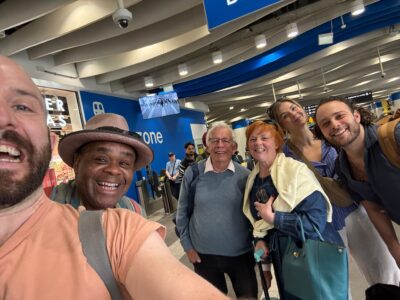 Gavin Dent takes a selfie of himself, Clive Rowe, Chris Walker, Sophie-Louise Dann, Amy Parker & Jack Reitman at a train station.